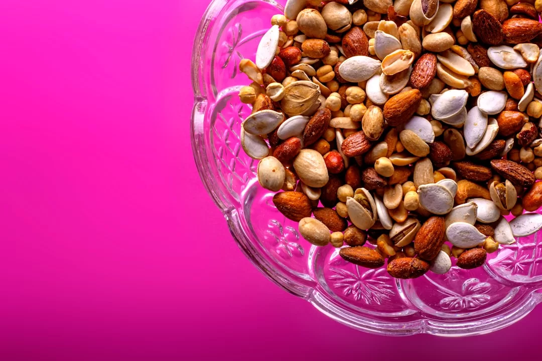 brown almond nuts on clear glass bowl Health Benefits Of Eating Dry Fruits